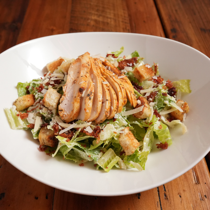 Large Caesar salad with grilled chicken, one of JZ's Pizza's $16 lunch specials