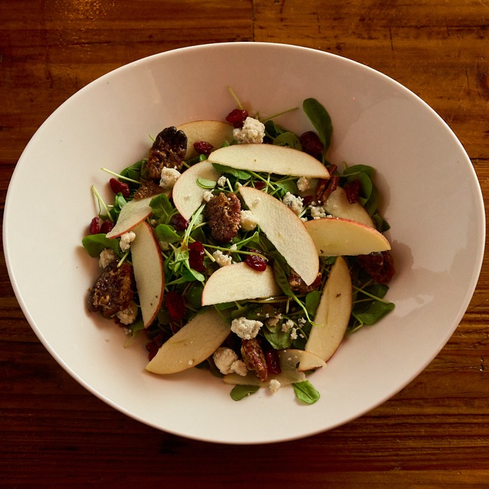 Apple pecan salad with arugula, sliced apples, candied pecans, dried cranberries and gorgonzola