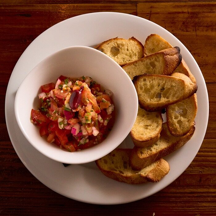Bruschetta with diced tomato, red onion and herbs, served with toasted garlic baguette