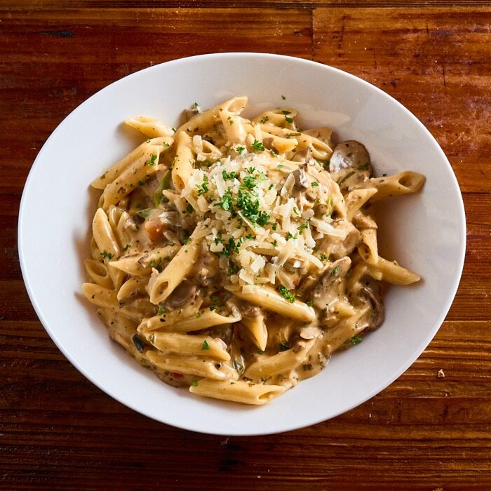 Chicken alfredo penne with mushrooms and shaved parmesan