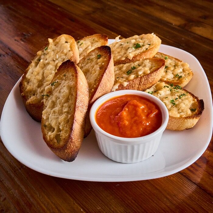 Garlic parmesan toast with garlic herb butter and a side of marinara