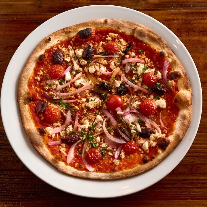 Grecco pizza with feta, kalamata olives, red onion and cherry tomatoes