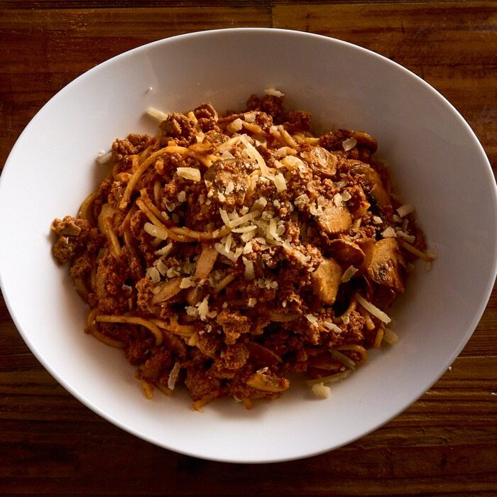 Spaghetti bolognese with ground beef tomato sauce, mushrooms and parmesan
